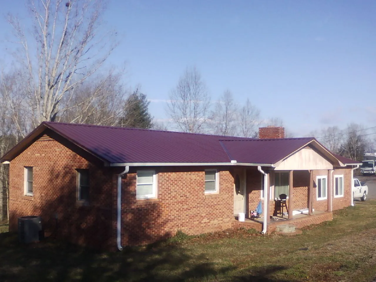 Burgundy metal roof on a brick ranch home with a new addition in Springfield